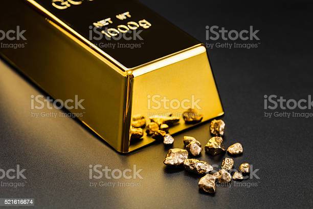 gold bullion and nuggets on a dark background